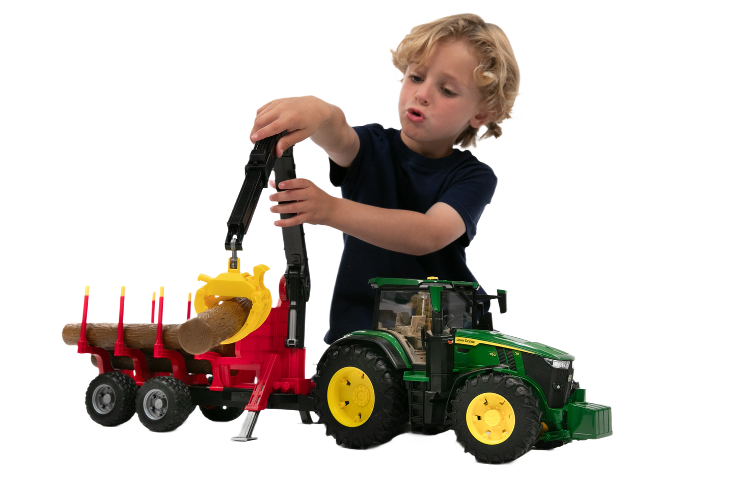 Child playing with green and yellow tractor and red forestry trailer loading wooden logs for imaginative home improvement play