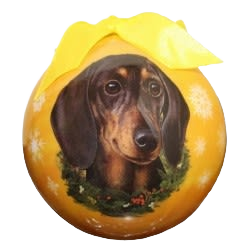 Yellow Christmas ball ornament featuring a black dachshund portrait and festive wreath in holiday decorations collections