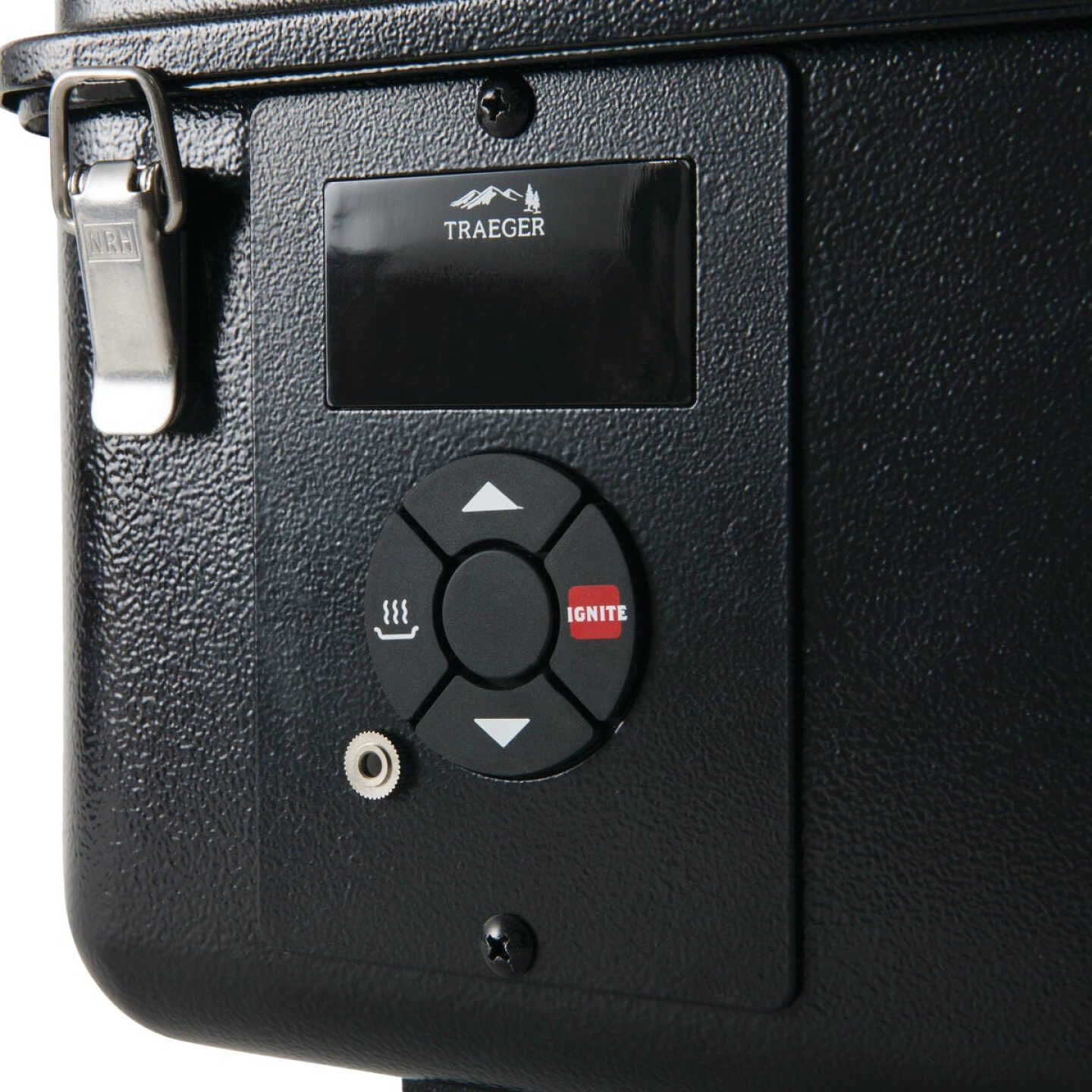 Close-up of black pellet grill digital control panel with ignition button and temperature adjustment for outdoor grilling