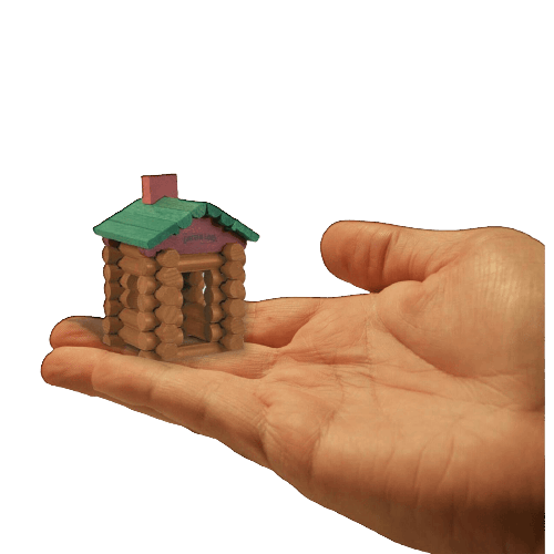 Hand holding a miniature log cabin built with tiny wooden logs from a pretend play toy collection under $50