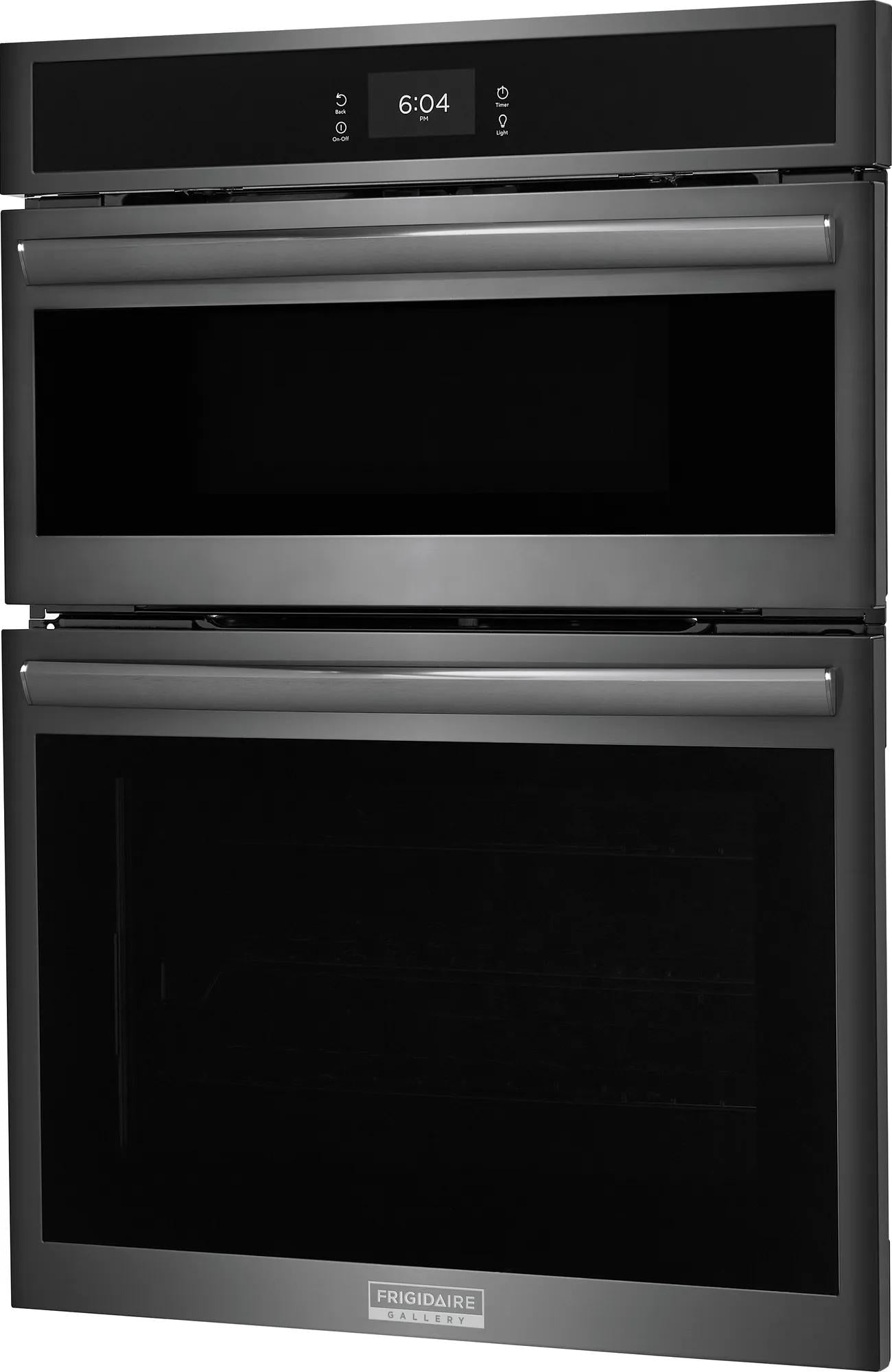 Black stainless steel 30" electric wall oven and microwave combo with digital clock and sleek handle design in modern kitchen appliances