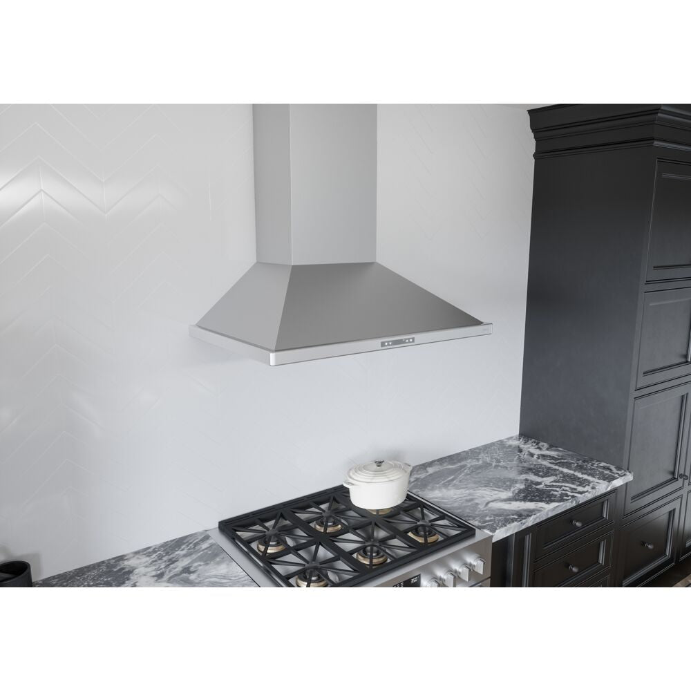 Wall mounted stainless steel chimney range hood above gas cooktop on marble countertop in modern kitchen appliances collection