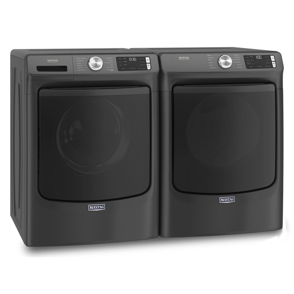 Pair of matte black front load washer and electric dryer units with digital displays and control knobs in laundry appliance set