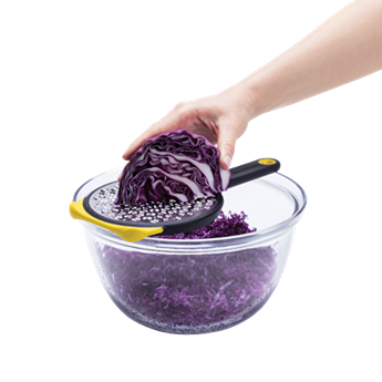 Hand grating purple cabbage using a yellow medium two-sided speed grater for kitchen gadgets and tools under $50 collections