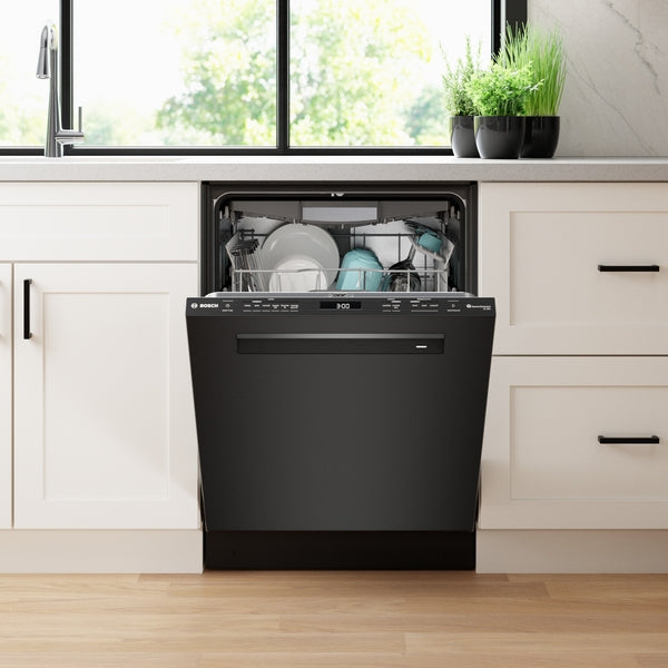 Built-in black steel dishwasher with digital display open showing clean dishes in modern kitchen setting