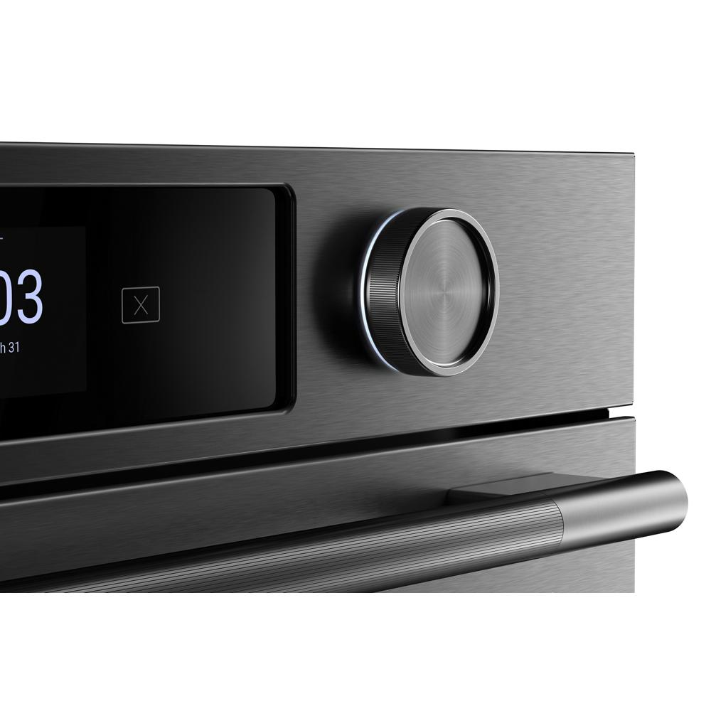 Close-up of brushed stainless steel wall oven control knob and LED touchscreen panel from KitchenAid appliances collection
