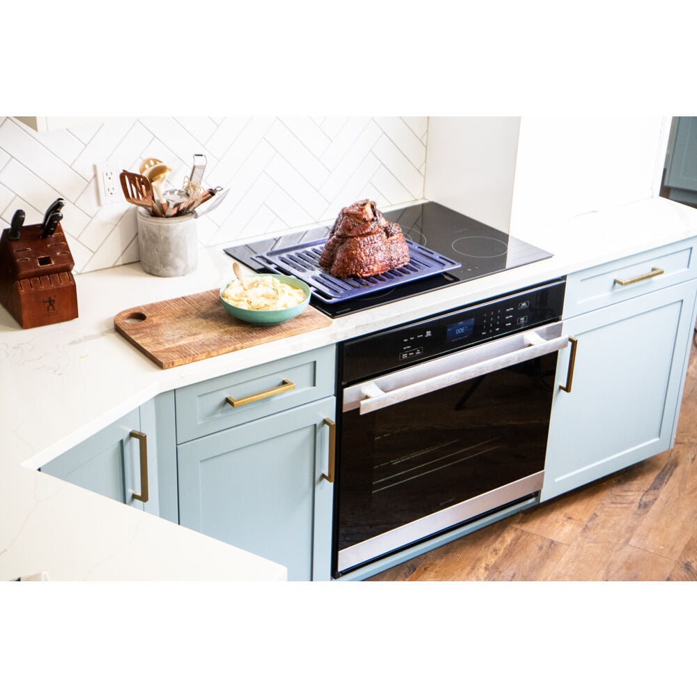 Built-in electric wall oven with true convection, black glass front, and stainless steel handle in modern kitchen setting