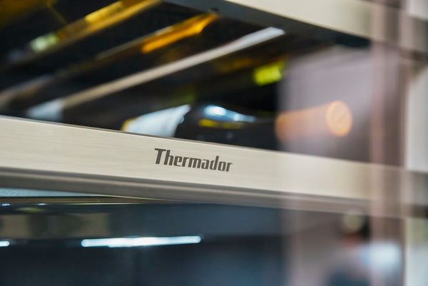 Close-up of stainless steel handle on Thermador built-in wine cooler in kitchen appliances collection