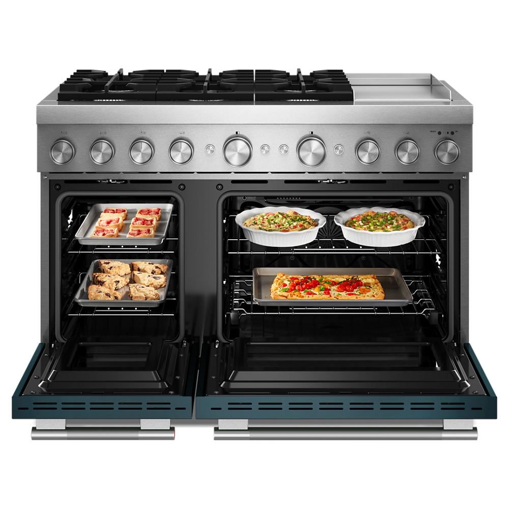 Dual fuel 48-inch stainless steel range with six burners, electric double ovens baking cookies, pizza, and casseroles