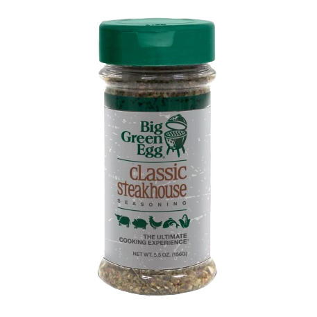 Clear plastic shaker of Big Green Egg classic steakhouse seasoning with green lid in grilling spices collection