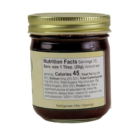Glass jar of Hartville Kitchen Christmas Jam with gold lid showing nutrition facts label in jams & jellies collection under $25
