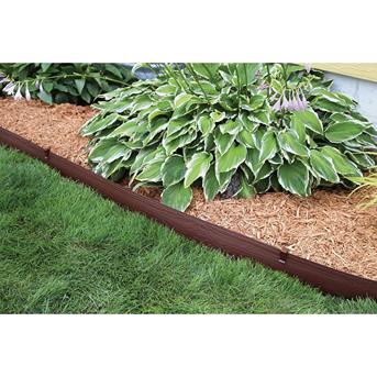 Brown garden edging stakes with clips installed between lawn and mulch bed for home improvement tasks