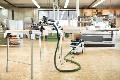 Festool router setup on guide rail with dust extractor in spacious woodworking shop for precise home improvement tasks