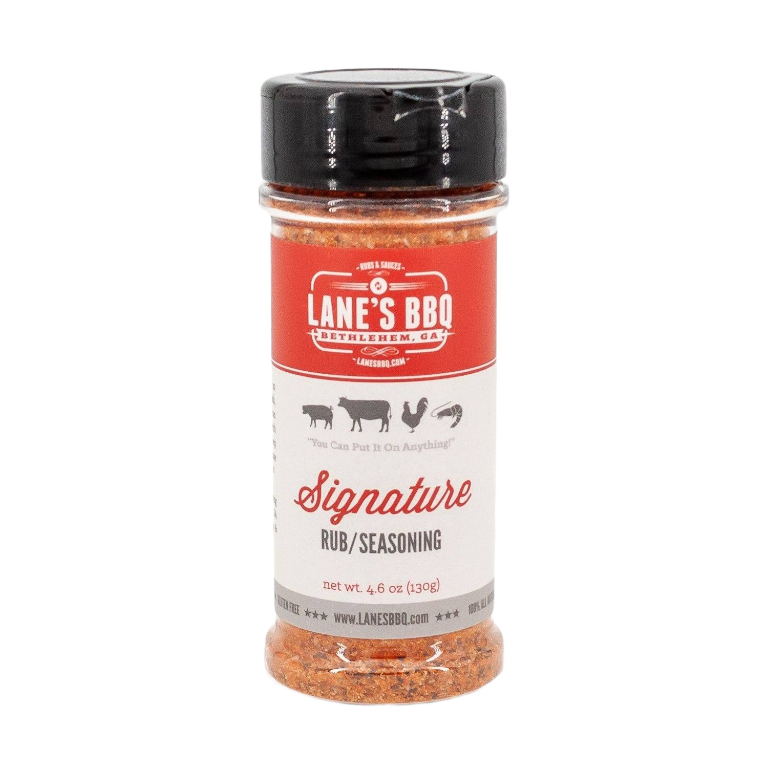 Clear plastic spice bottle with black lid containing Lane's Signature Rub seasoning blend for grilling and BBQ use