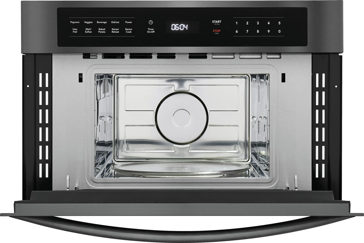 Built-in microwave oven with drop-down door, digital control panel, and stainless steel interior in kitchen appliances collection