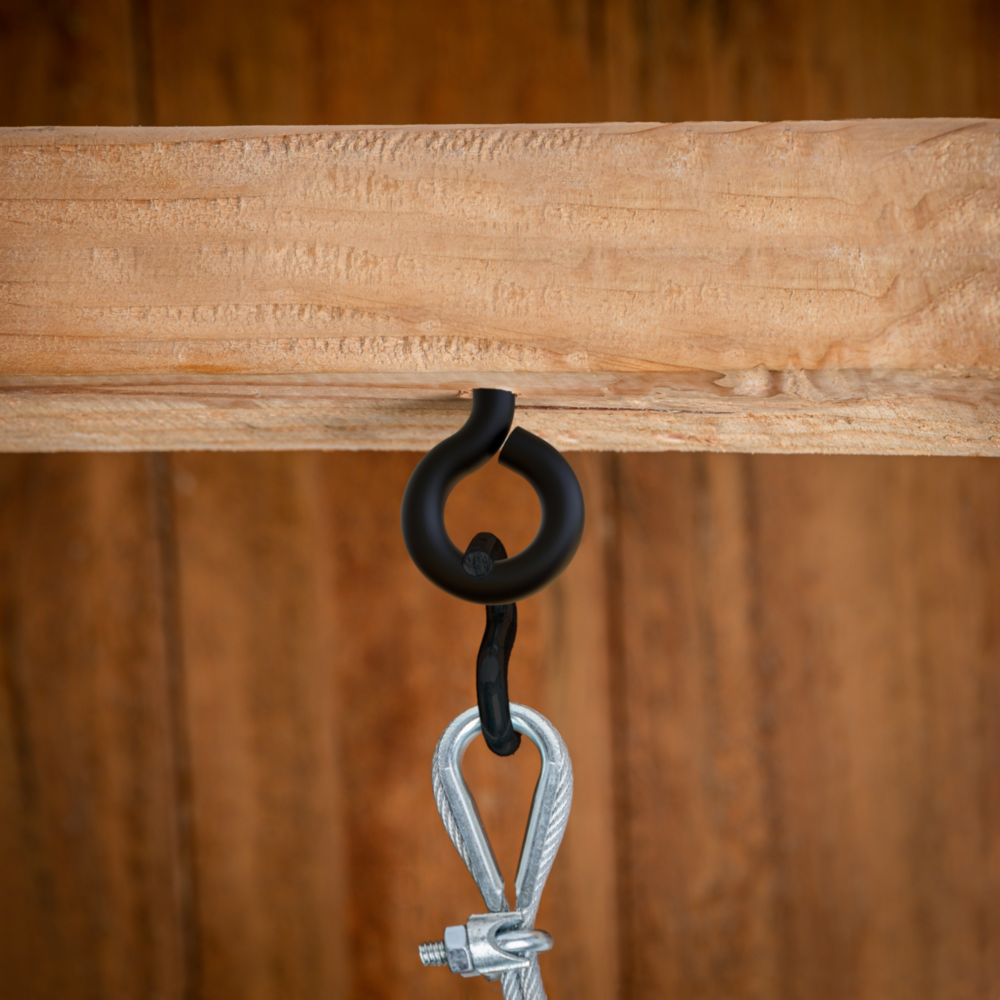 Black Storm Shine screw eye installed in wood holding a metal clip for tools in hardware and fasteners collection