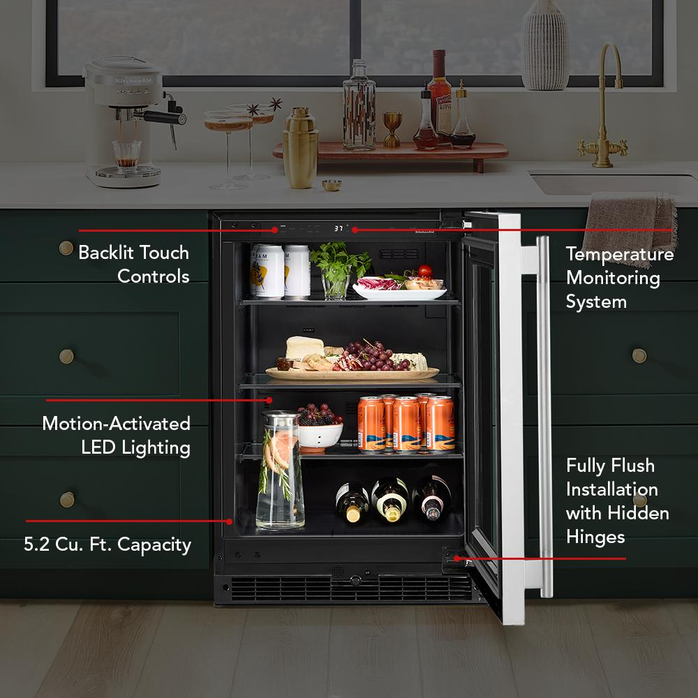 Undercounter refrigerator with glass door, interior LED lighting, stocked shelves, and temperature monitoring in modern kitchen setup