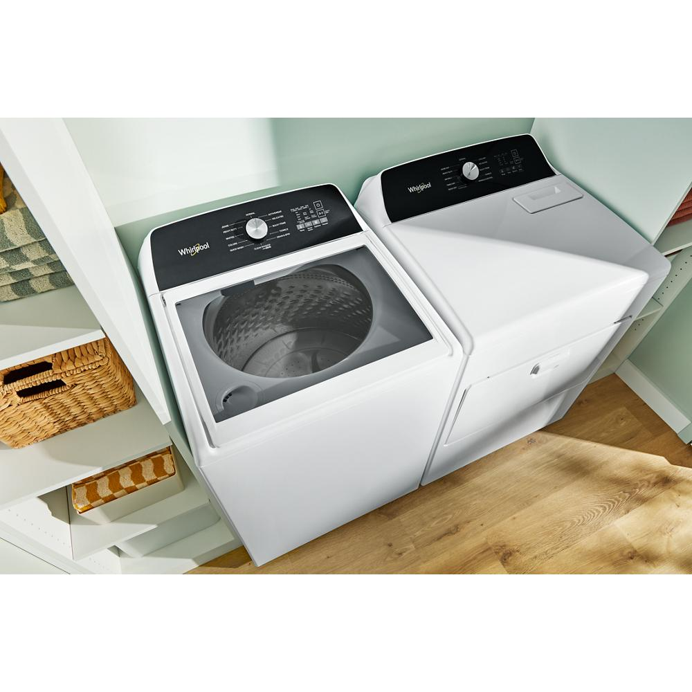 White top load washer with impeller and matching dryer in organized laundry room with shelving and baskets