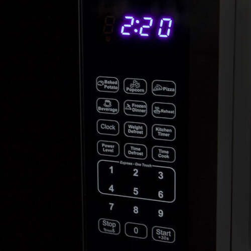 Close-up of microwave control panel with preset cooking options and digital clock in kitchen appliance setting