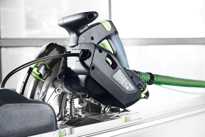 Close-up of Festool plunge cut track saw with dust extraction hose in workshop setting for power tools and home improvement