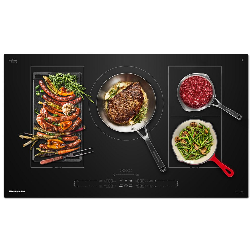 Black induction cooktop with five active cooking zones holding skillet, grill pan with vegetables and saucepans with food