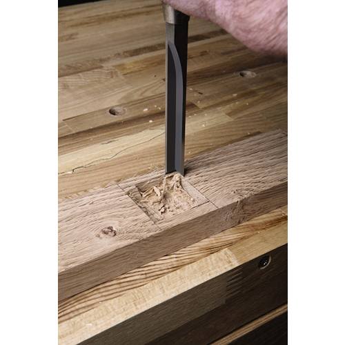 Hand tool cutting precise square mortise in oak wood for woodworking and home improvement projects