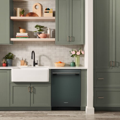 Matte dark green KitchenAid dishwasher with towel bar handle integrated into green kitchen cabinetry from dishwashers collection