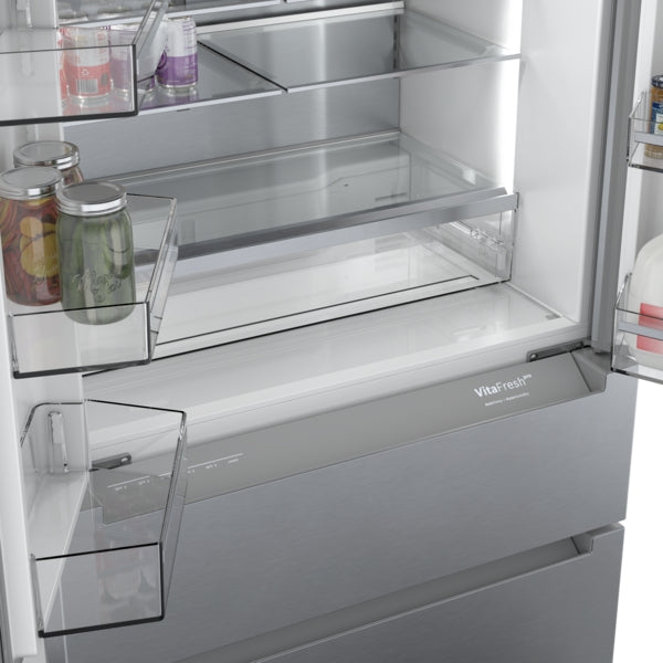 Interior view of stainless steel French door refrigerator with empty shelves and storage compartments from Bosch collection
