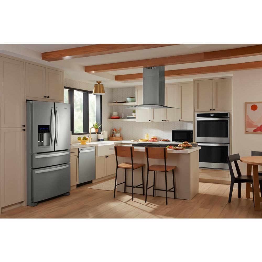 Contemporary kitchen showcasing stainless steel appliances and a curved glass island mount range hood from Island Range Hoods collection