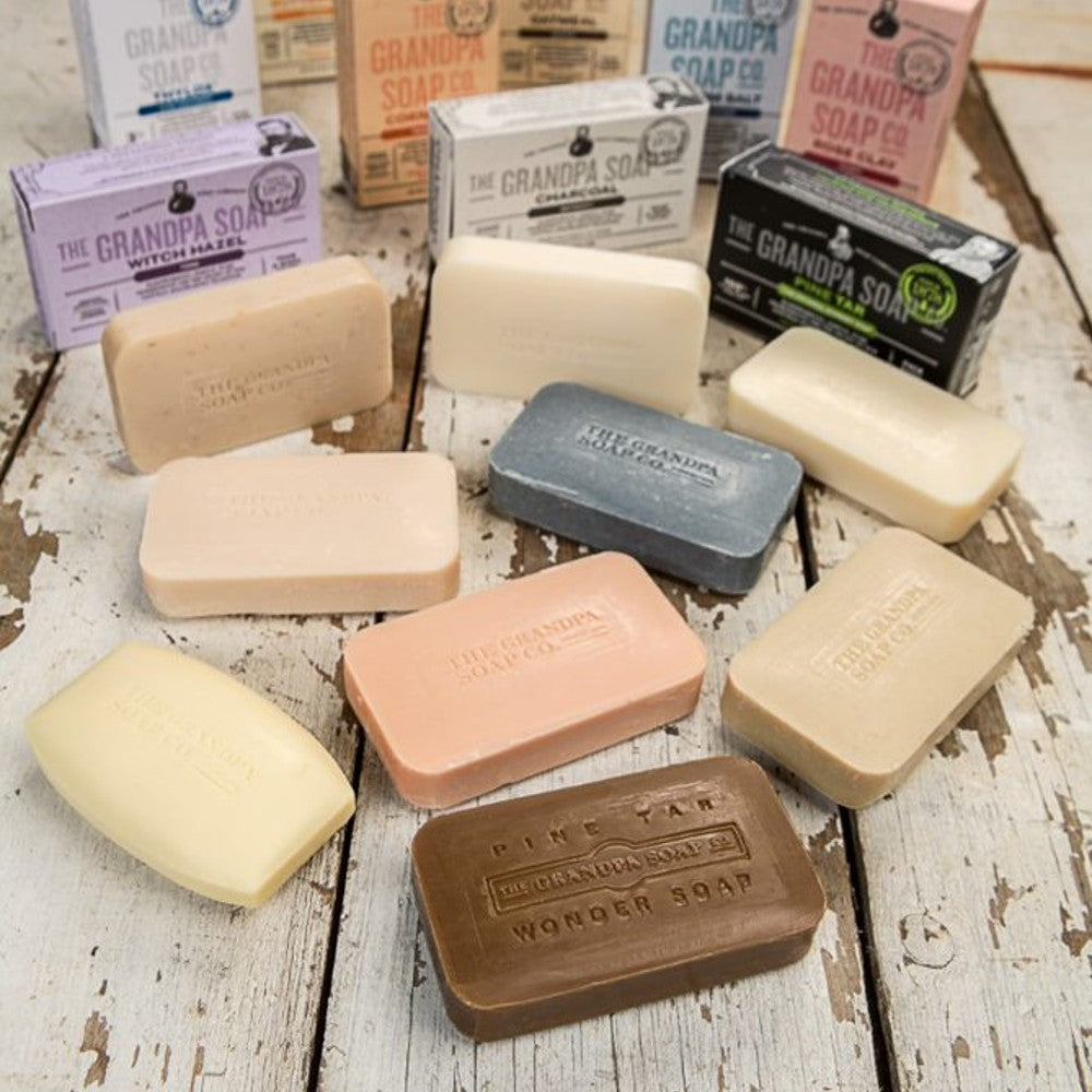 Assorted rectangular soap bars in various natural shades with embossed logos for Health & Beauty collections under $50