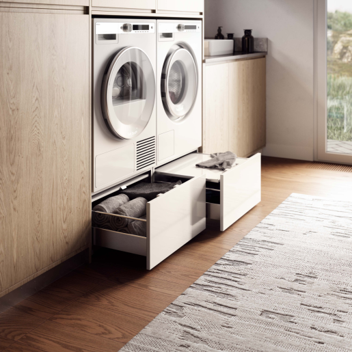 White pull-out drawer beneath laundry machines for organized storage in home improvement and appliance parts settings