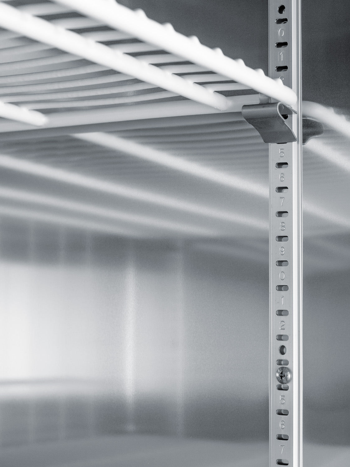 Adjustable wire shelf inside a stainless steel upright pharmacy freezer for medical and laboratory use in appliances collection