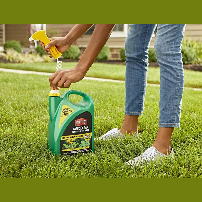 Person attaching yellow trigger to green Ortho WeedClear weed killer container on lawn for garden care under $50