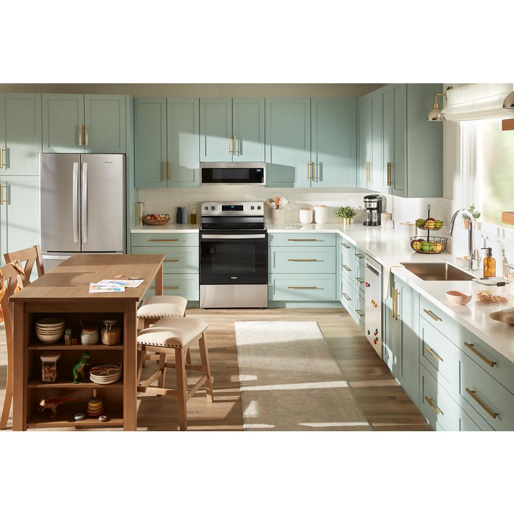 Modern kitchen featuring stainless steel electric range with oven, surrounded by pastel green cabinetry and wood flooring