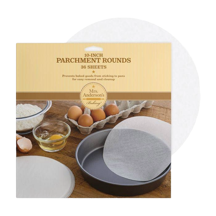 Package of 36 ten-inch round parchment sheets for baking, shown with eggs and flour in a kitchenware setting