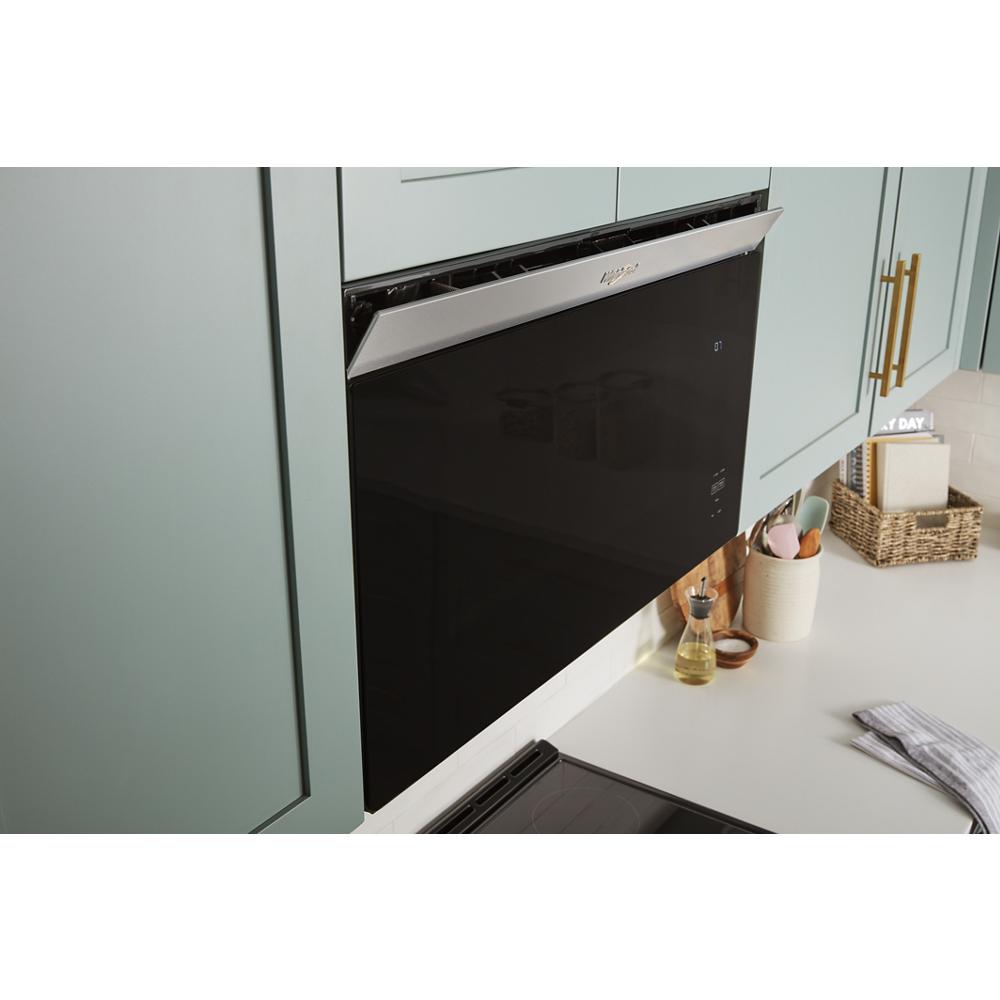 Built-in microwave with flush mount black front and stainless steel trim installed in modern kitchen setup
