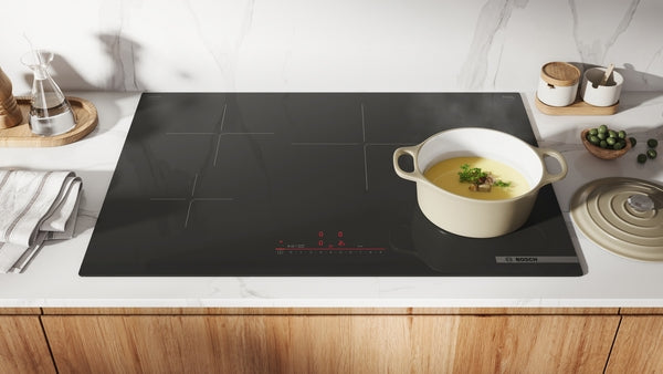 30-inch black induction cooktop with four cooking zones and touch controls for modern kitchen and home improvement use