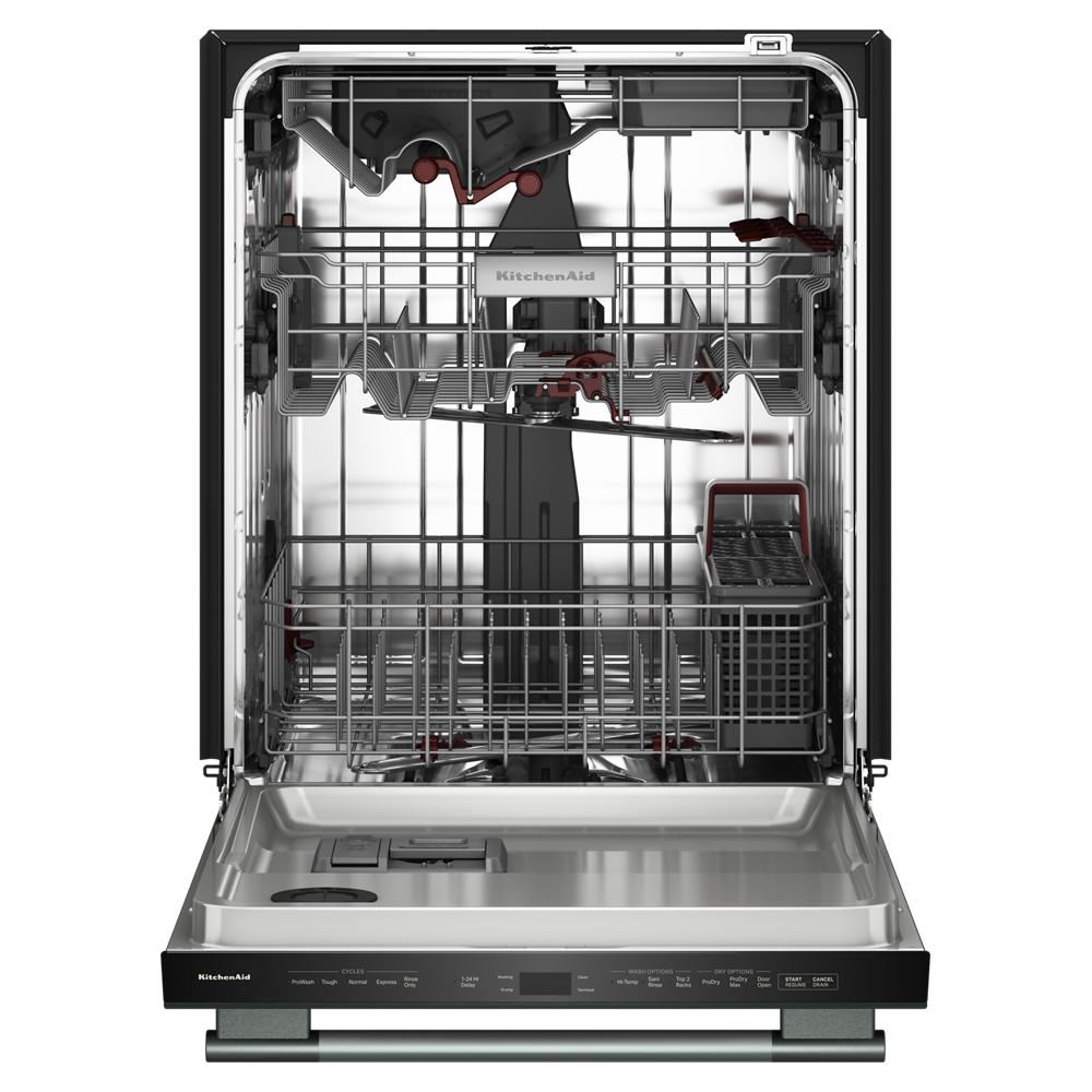 Open stainless steel KitchenAid dishwasher interior showing multiple racks and utensil basket for kitchenware cleaning.
