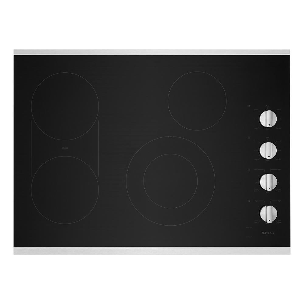 Black electric cooktop with four burners and four white control knobs from Kitchen & Kitchenware cooktops collection