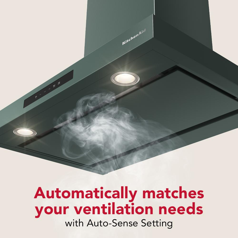 Matte dark green wall-mounted canopy hood with lights and automatic ventilation control for kitchen air quality.