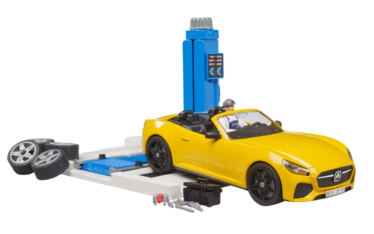 Yellow toy roadster on car lift with spare tires and mechanic figure in play car service center set