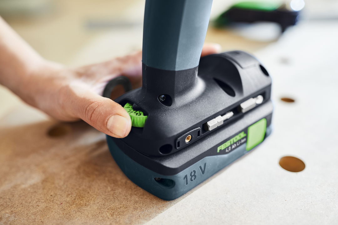 Hand adjusting torque settings on a Festool cordless drill battery for woodworking and power tool tasks