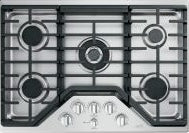 Top view of stainless steel five-burner gas cooktop with control knobs in kitchen appliances collection