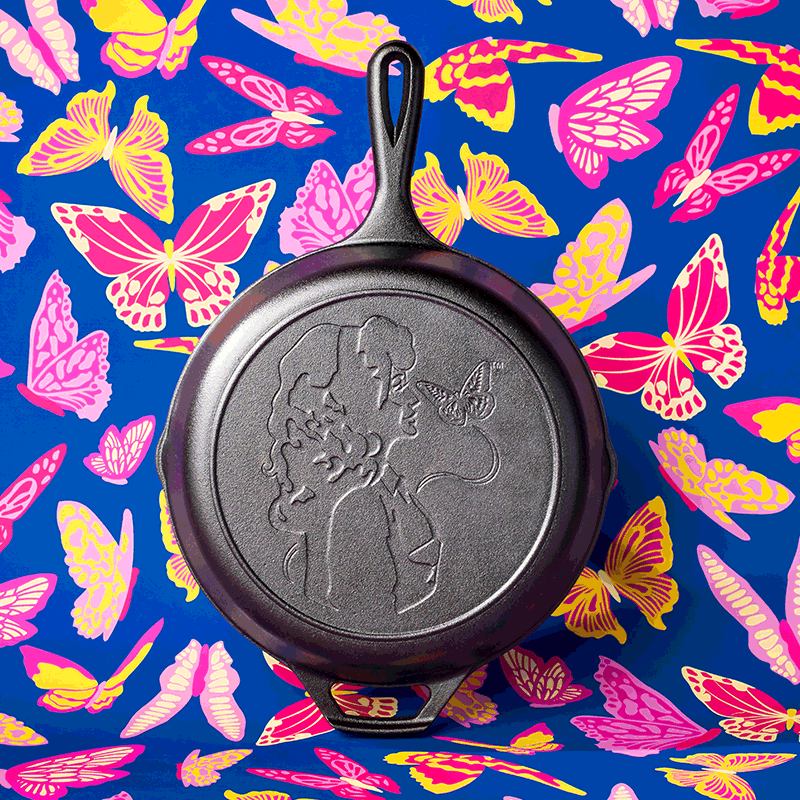 Cast iron skillet with embossed Dolly Parton profile and butterfly design, part of Lodge Cast Iron kitchenware collection under $100
