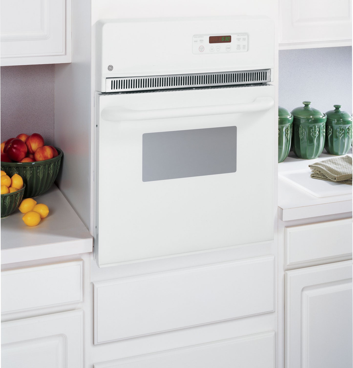 White built-in electric wall oven with digital display and self-cleaning feature in modern kitchen setting from Wall Ovens collection