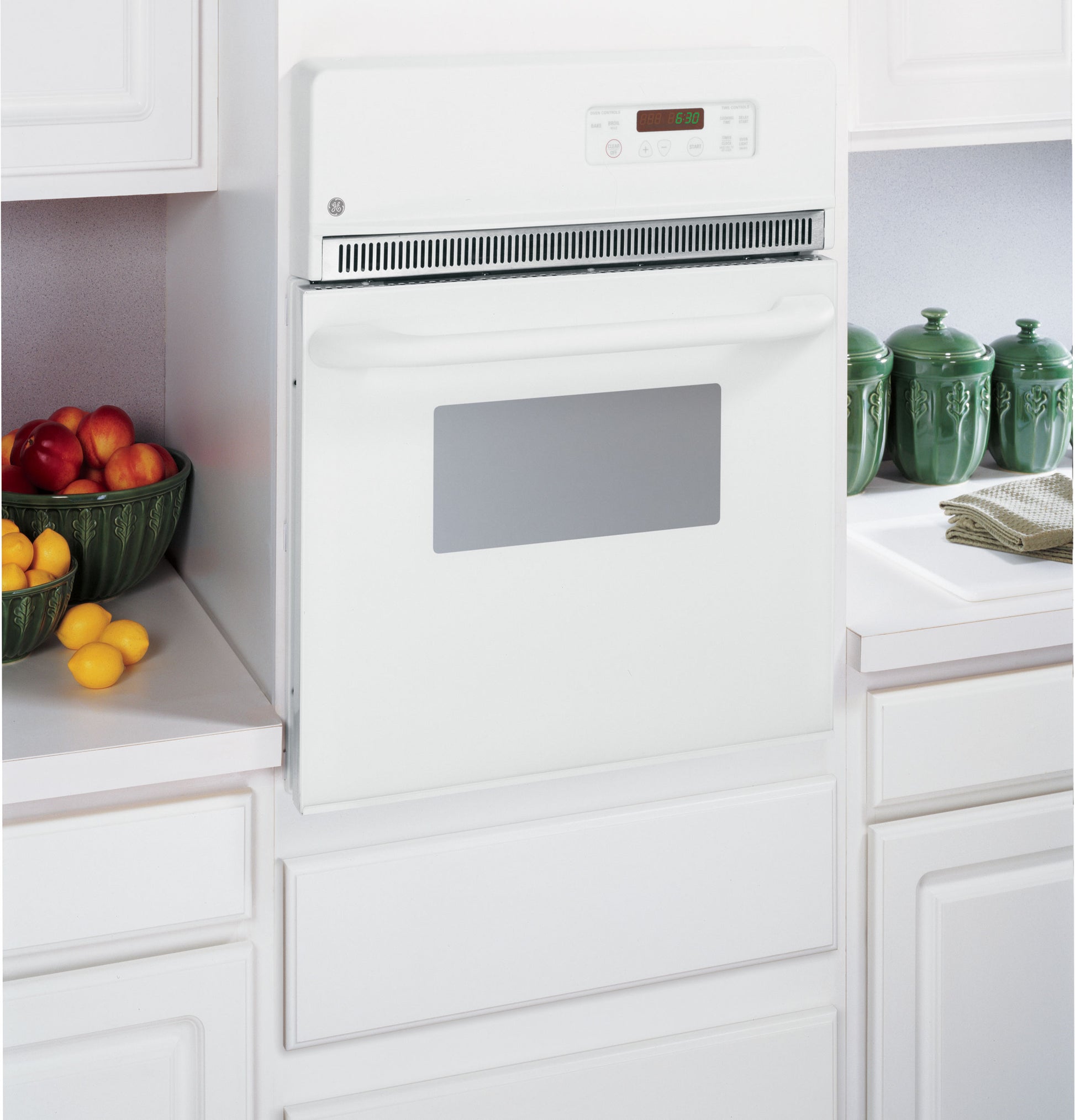White built-in electric wall oven with digital display and self-cleaning feature in modern kitchen setting from Wall Ovens collection