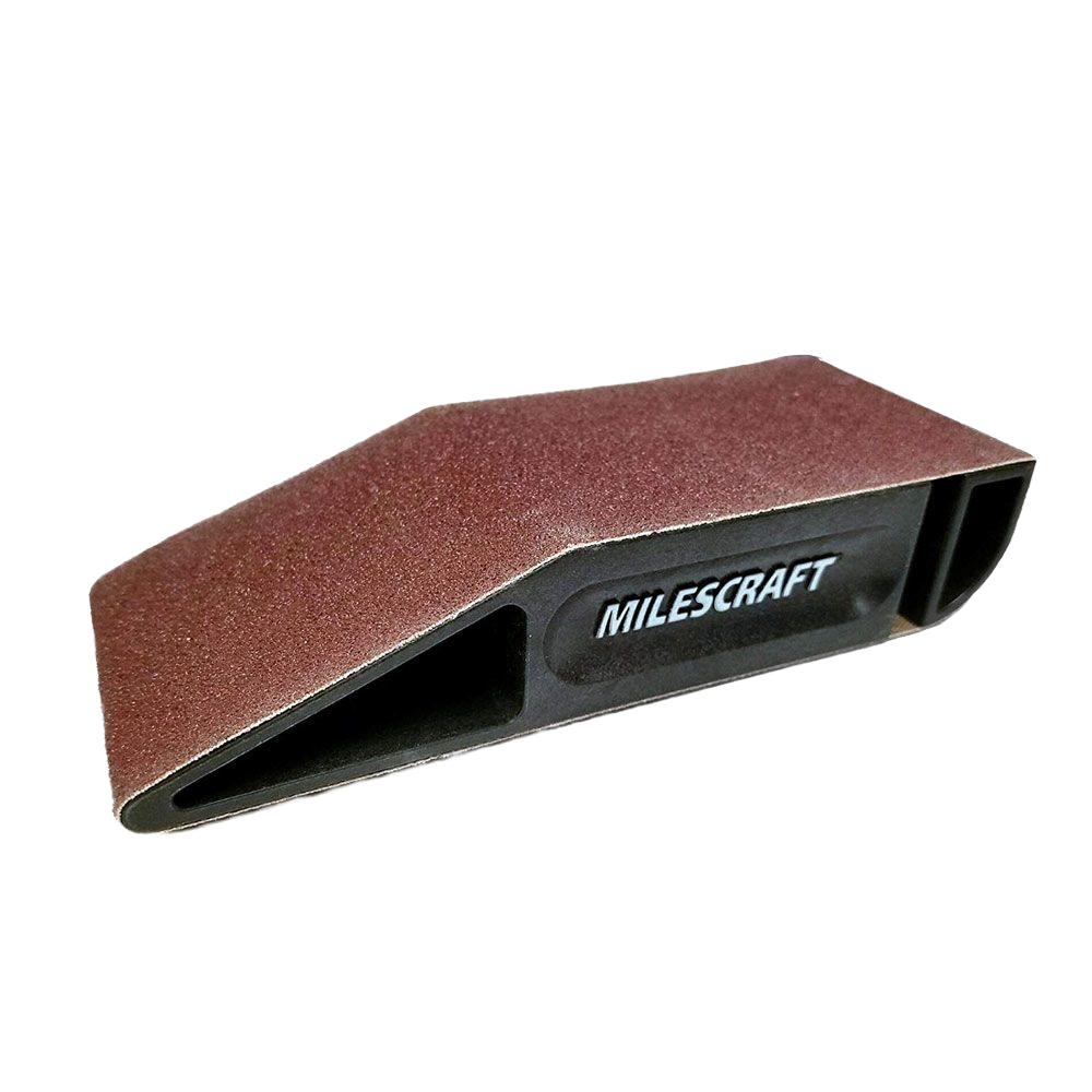 Compact hand sanding block with durable sanding belt and ergonomic black plastic frame for woodworking and home improvement tasks