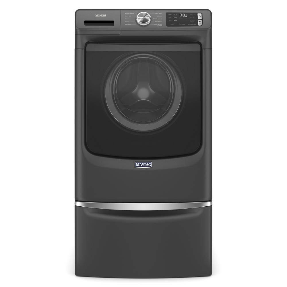 Dark gray front load washing machine with digital display and storage pedestal base for laundry accessories