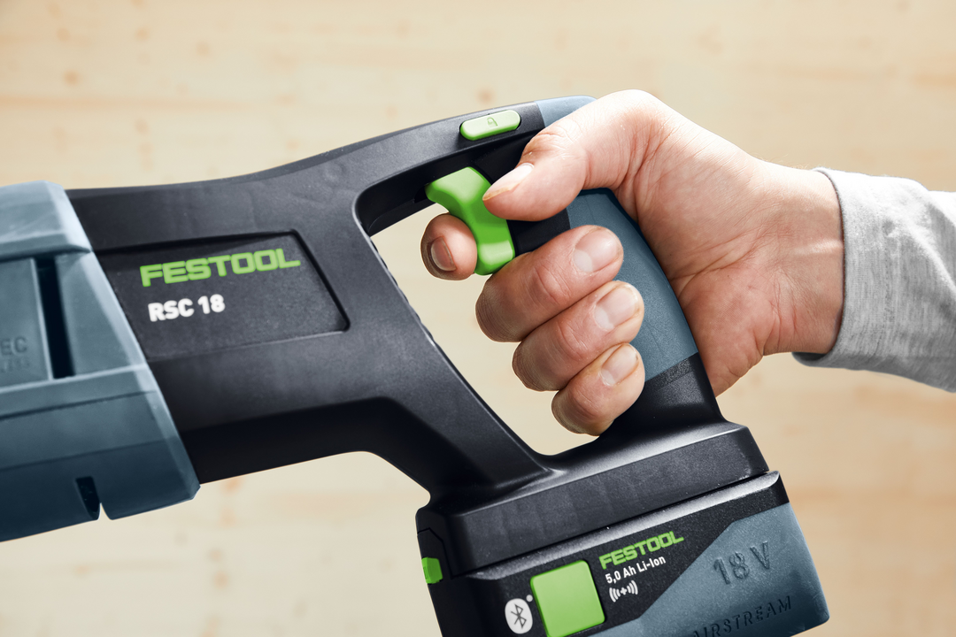 Hand gripping Festool cordless reciprocating saw handle with 18V battery, part of Festool cordless power tools collection