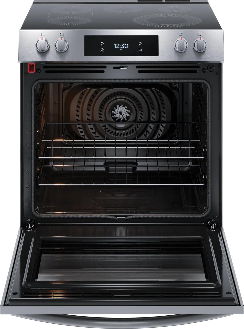 Front view of stainless steel electric range with open convection oven and glass cooktop in kitchen appliances collection